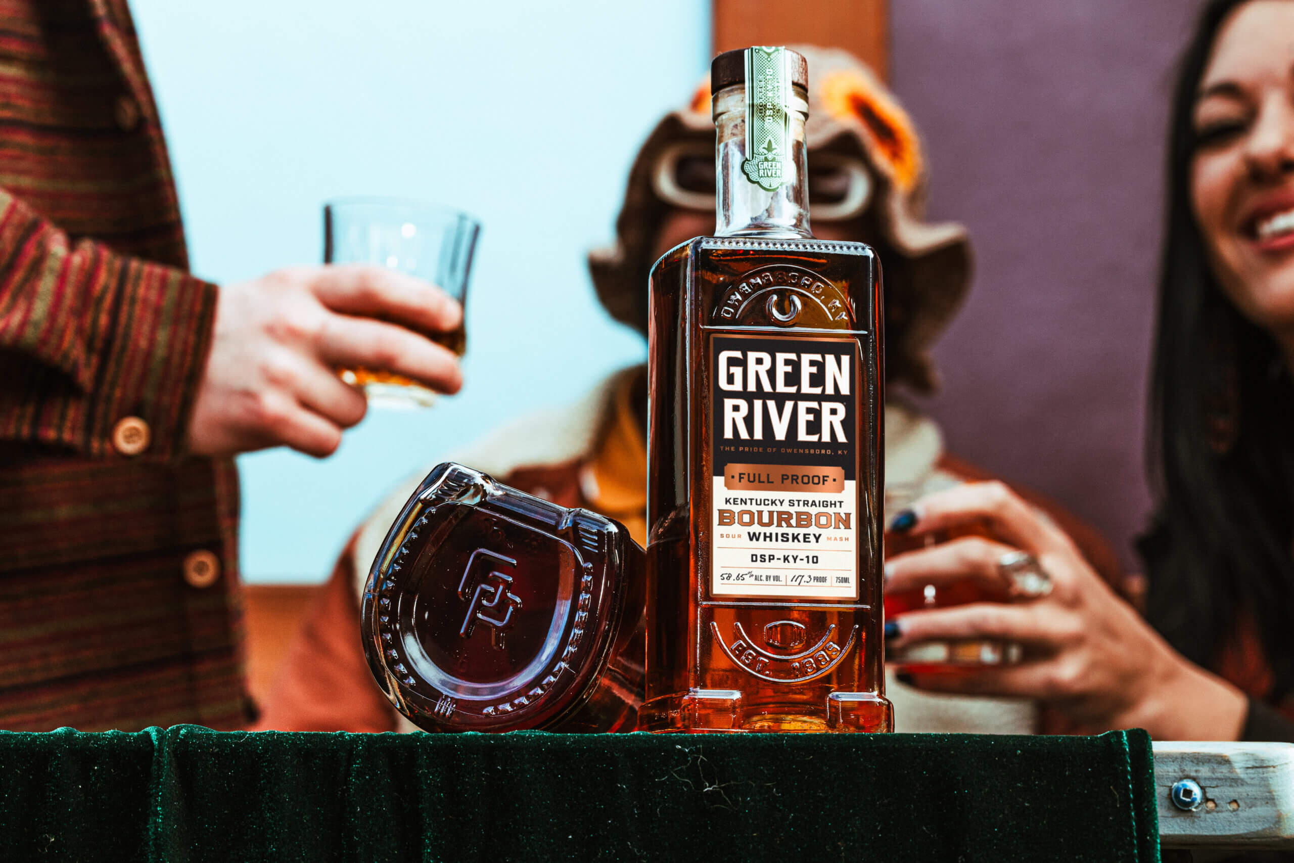 A group of people enjoy Green River’s Kentucky Straight Bourbon Whiskey.