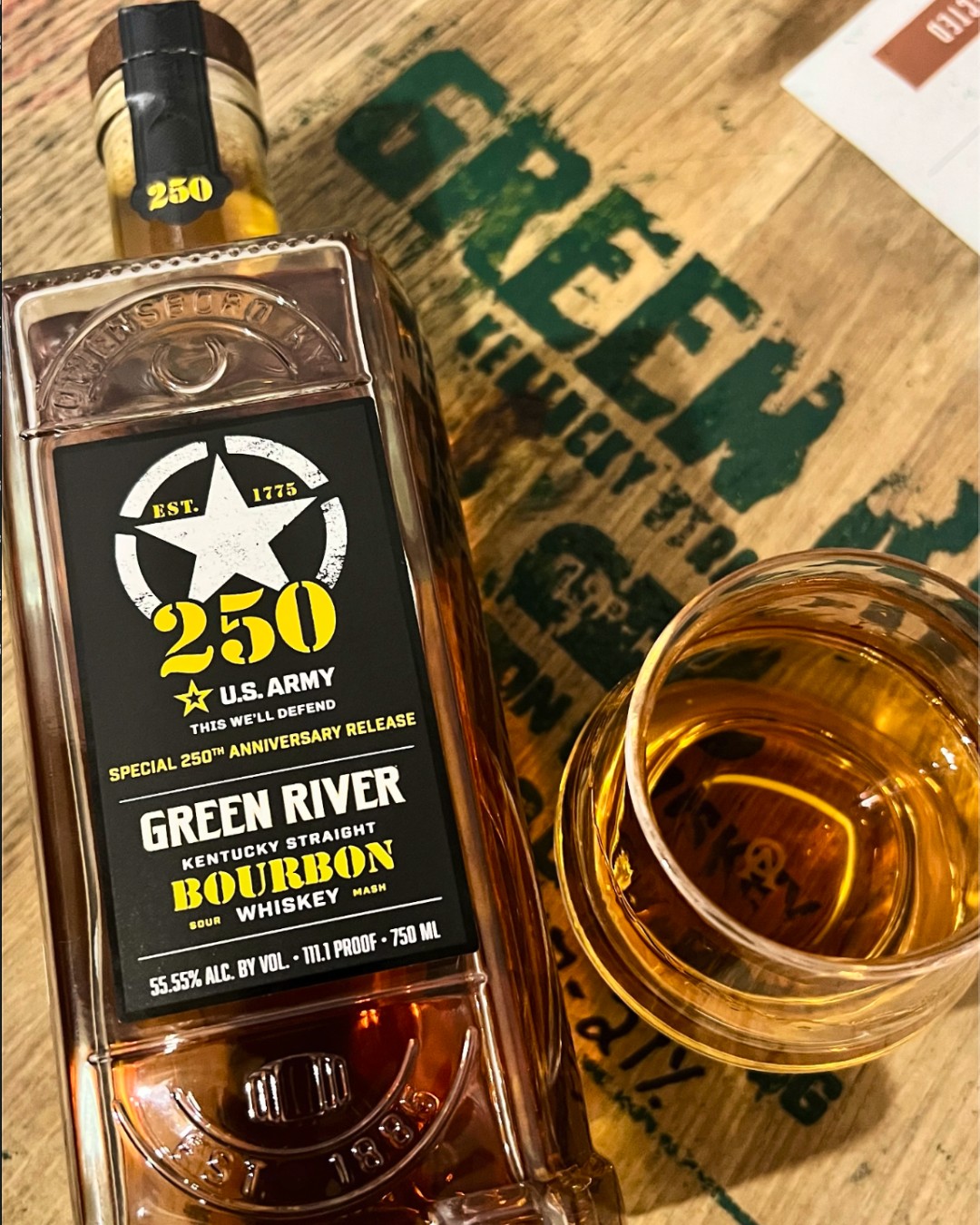 A flatlay shot of Green River Kentucky Straight Bourbon beside a glass of whiskey.