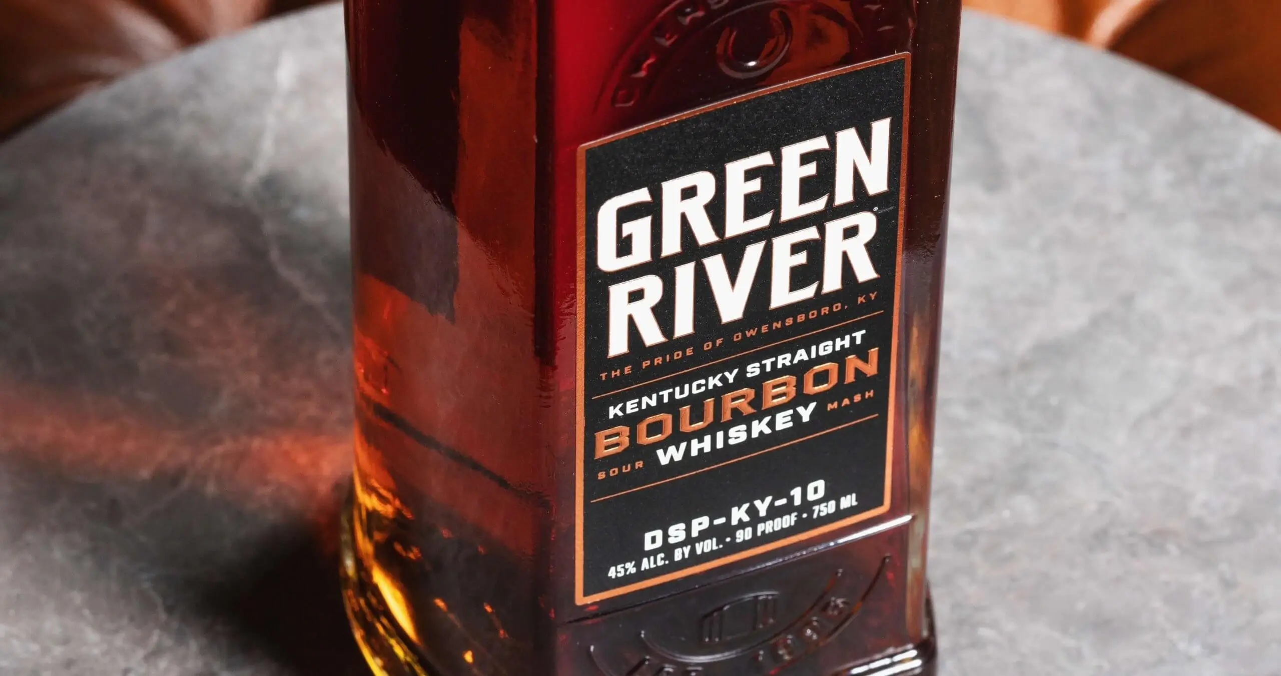 Green River Kentucky Straight Bourbon Whiskey bottle on leather surface