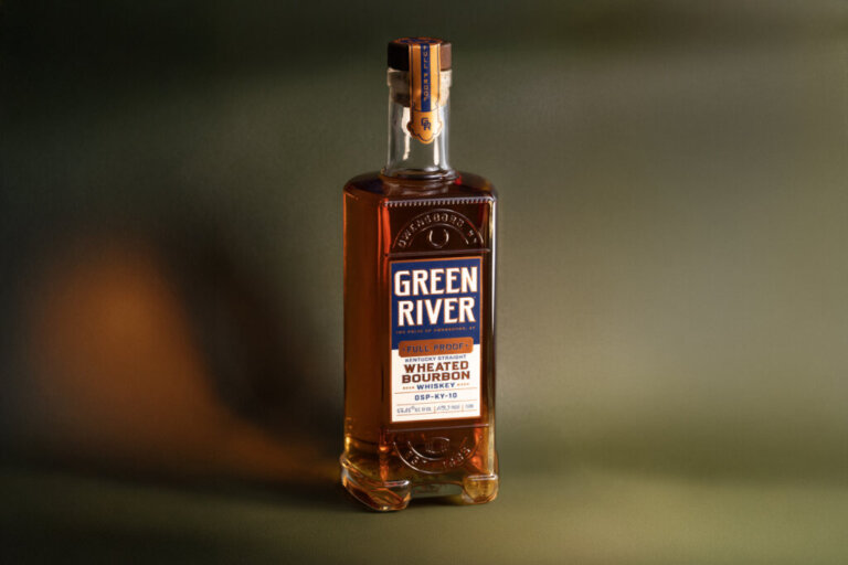 Green River wheated bourbon whiskey bottle with amber liquid and labeled blue and white branding.
