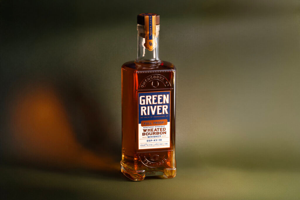 Green River wheated bourbon whiskey bottle with amber liquid and labeled blue and white branding.